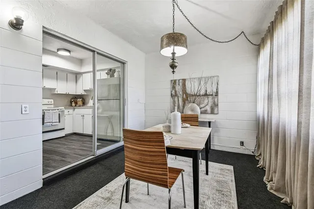 a view of a white house with a yard