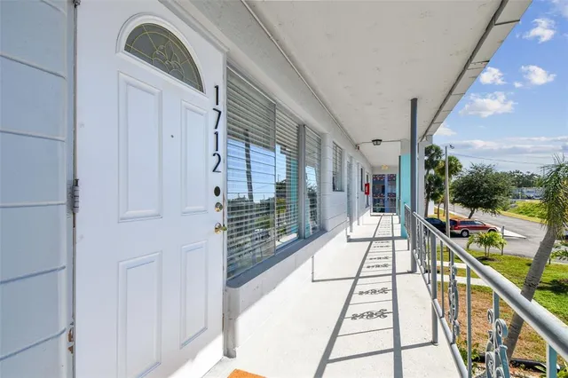 a living room with furniture a flat screen tv and a window
