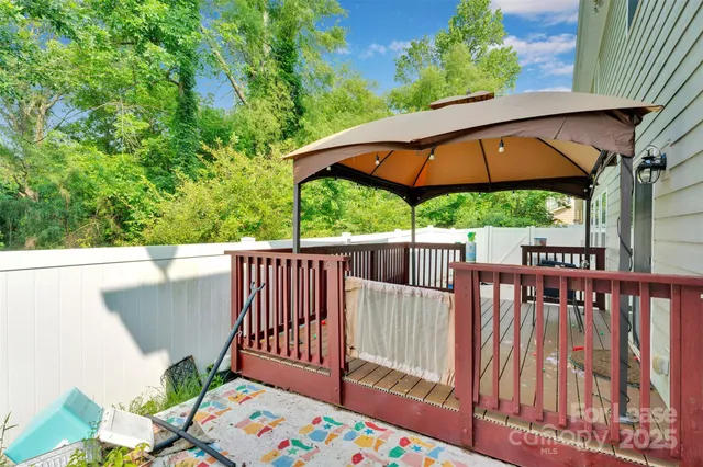 a view of a wooden deck and backyard with a garden