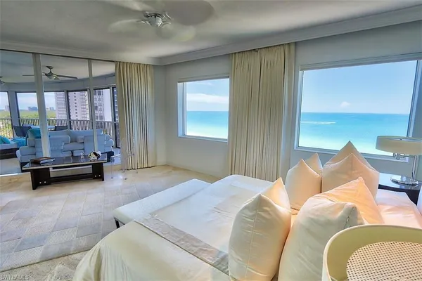 a bedroom with furniture and a large window