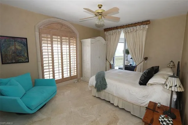 a bedroom with a bed window and couch