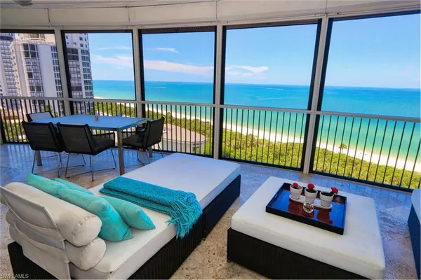 a bedroom with furniture and a large window