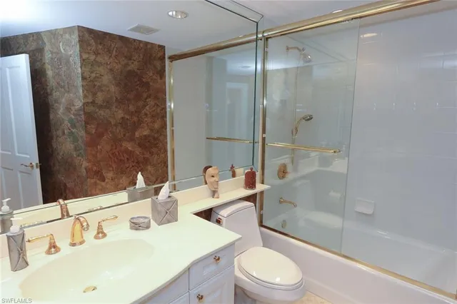 a bathroom with a sink mirror toilet and bathtub