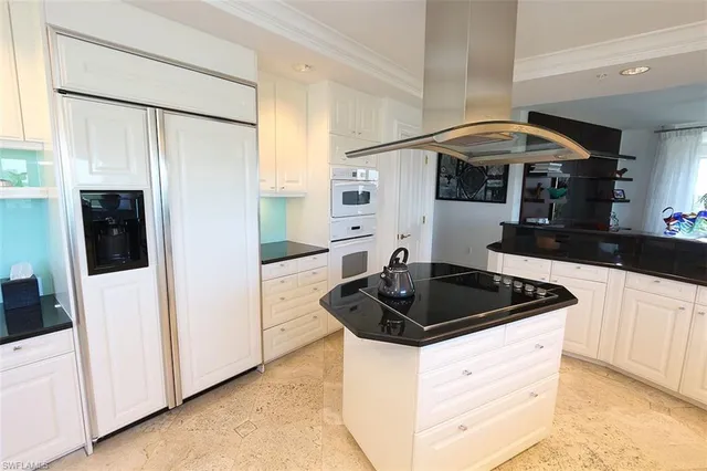a kitchen with stainless steel appliances granite countertop a sink and cabinets