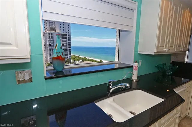 a bathroom with a sink a mirror and a window