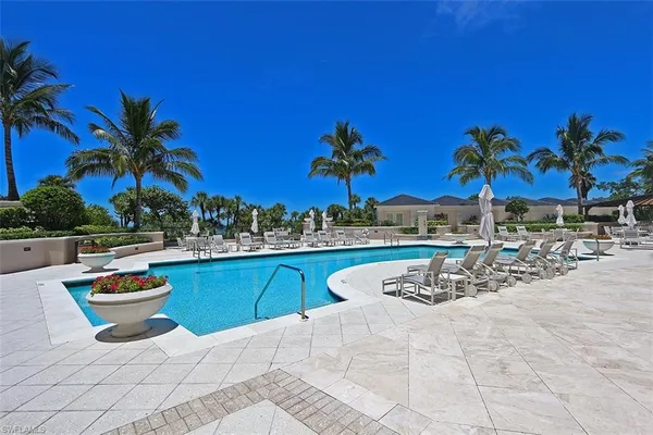 a view of a swimming pool with a table and chairs