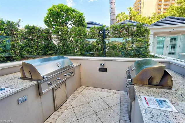 a living room with furniture and view of kitchen