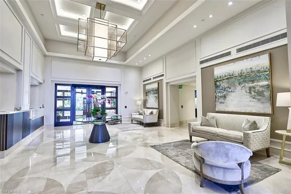 a living room with furniture or couch and a kitchen view