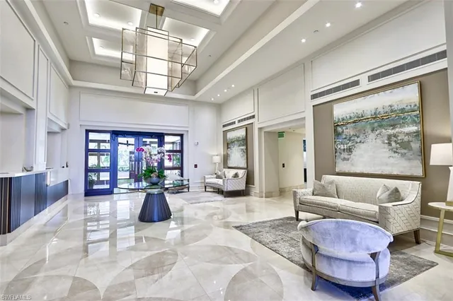 a living room with furniture or couch and a kitchen view