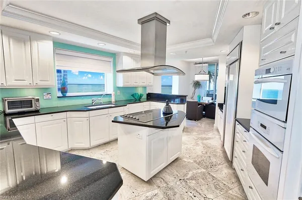 a kitchen with stainless steel appliances granite countertop a sink stove and cabinets