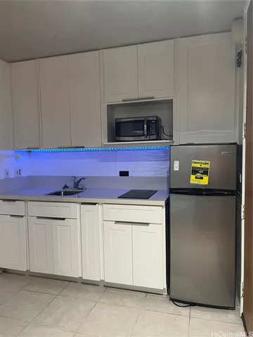 a kitchen with stainless steel appliances granite countertop a refrigerator and microwave