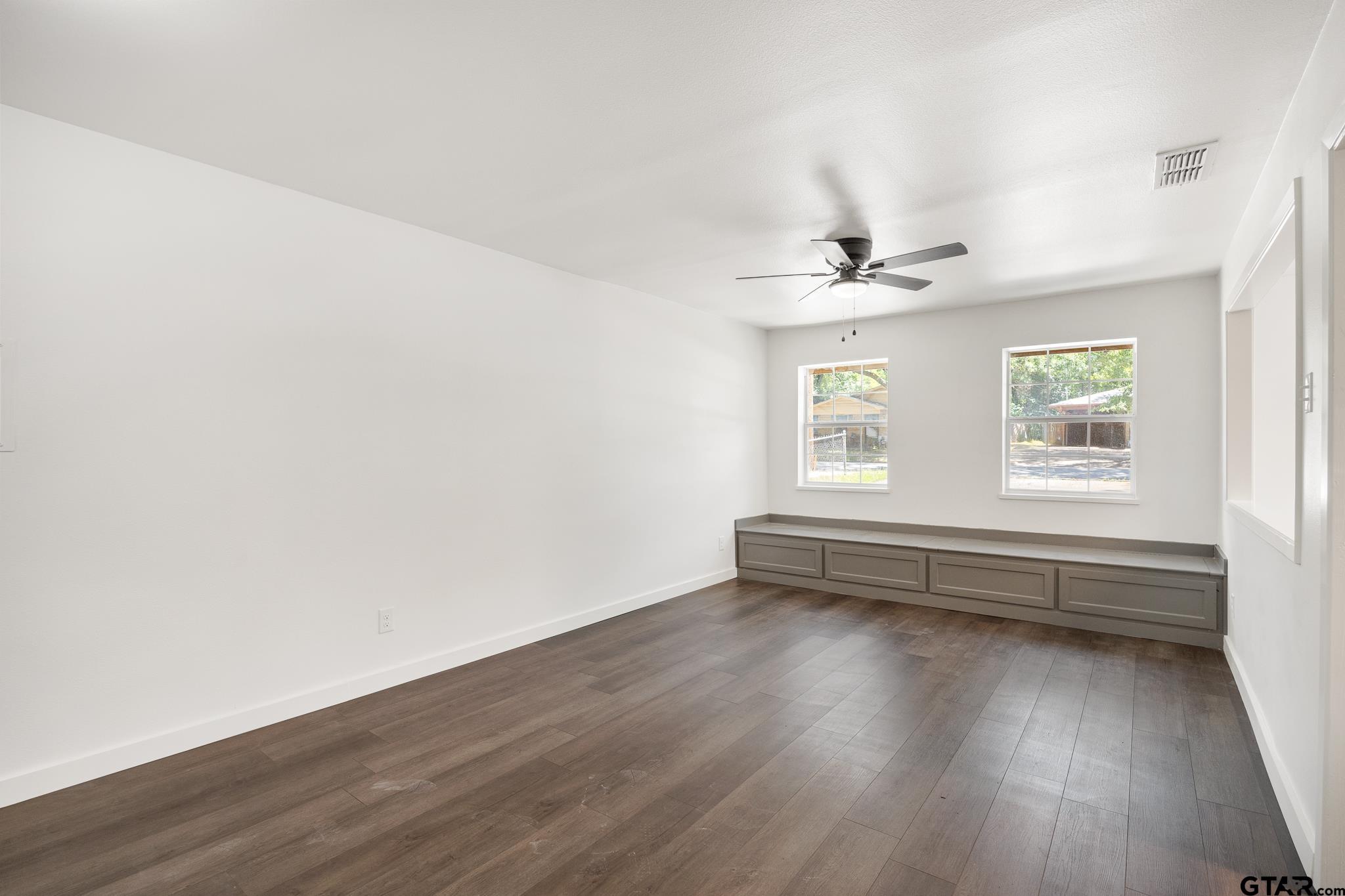 1538 North Hill Road Tyler, TX 75702 - Photo 14 of 29 an empty room with wooden floor and windows