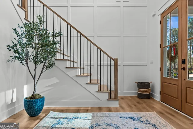 a bathroom with a double vanity sink a large mirror and shower