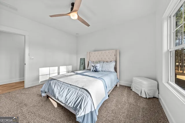 a living room with furniture and a ceiling fan