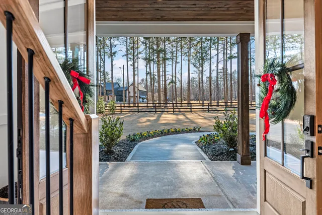 a living room with furniture and a floor to ceiling window