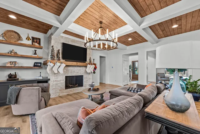 a kitchen with stainless steel appliances granite countertop a stove a sink dishwasher a dining table and chairs with wooden floor