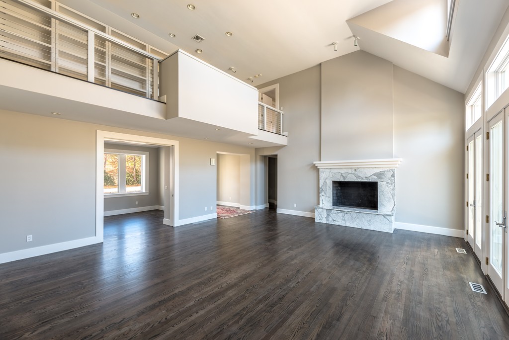 145 Willowbend Drive Mashpee, MA 02649 - Photo 11 of 16 a view of an empty room with wooden floor fireplace and a window