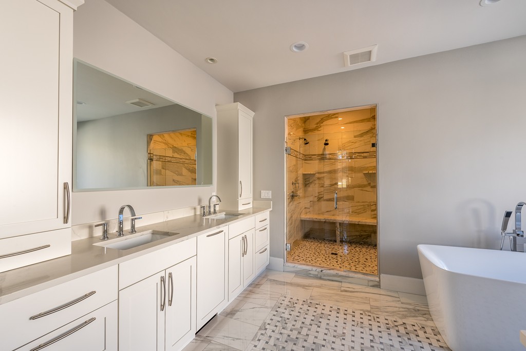 145 Willowbend Drive Mashpee, MA 02649 - Photo 14 of 16 a bathroom with a double vanity sink a mirror and a bathtub