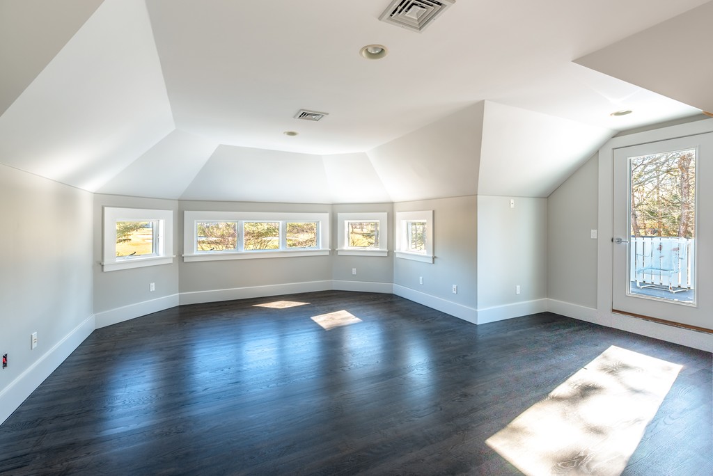 145 Willowbend Drive Mashpee, MA 02649 - Photo 5 of 16 an empty room with wooden floor and windows