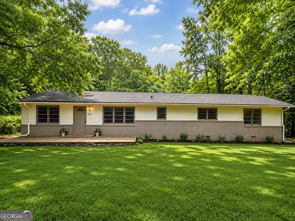 a front view of house with yard and green space