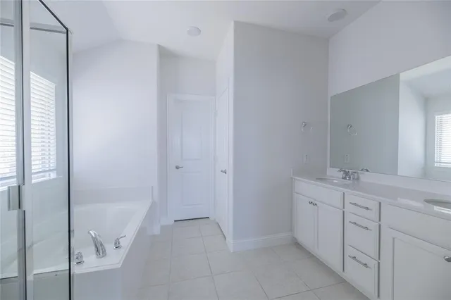a spacious bathroom with a granite countertop sink a mirror and a shower
