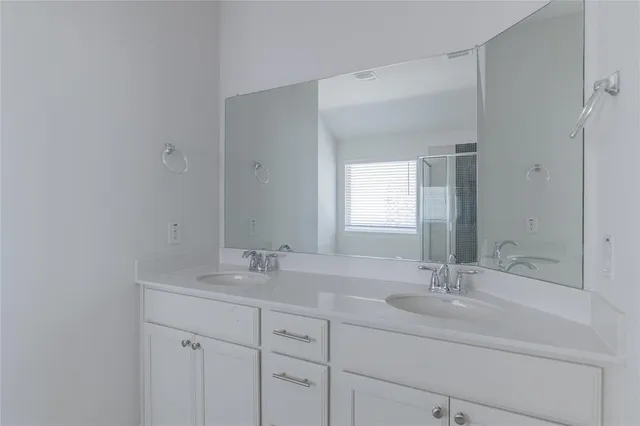 a bathroom with 2 sink and a mirror