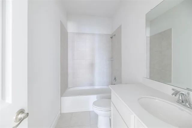 a bathroom with a toilet a sink and bathtub