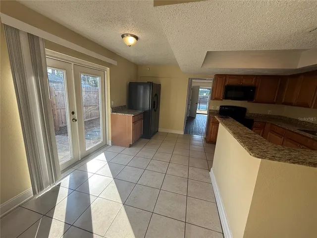 a view of living room kitchen with furniture and flat screen tv