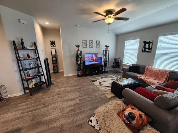 a living room with furniture and a flat screen tv