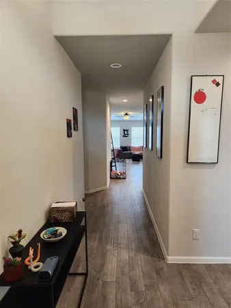 a hallway with furniture and wooden floor