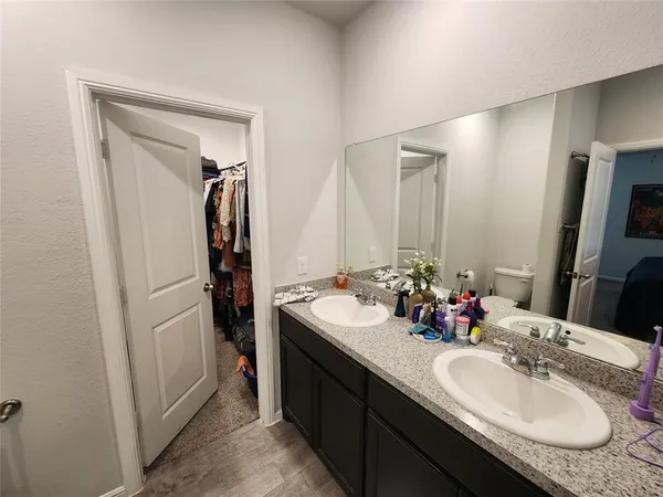 a bathroom with a double vanity sink and mirror