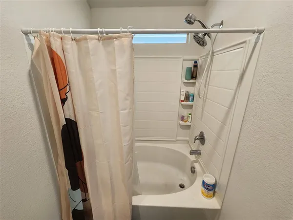 a bathroom with a shower and a tub