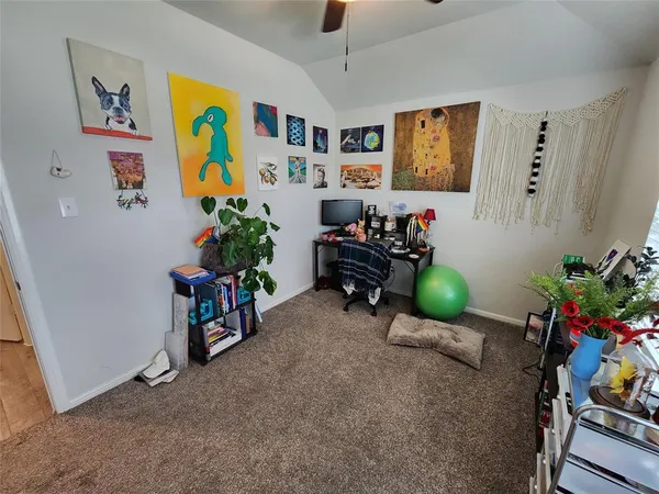 a room with painting on the wall and a window