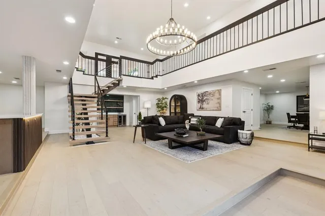 a living room with stainless steel appliances kitchen island granite countertop a couch and a view of living room