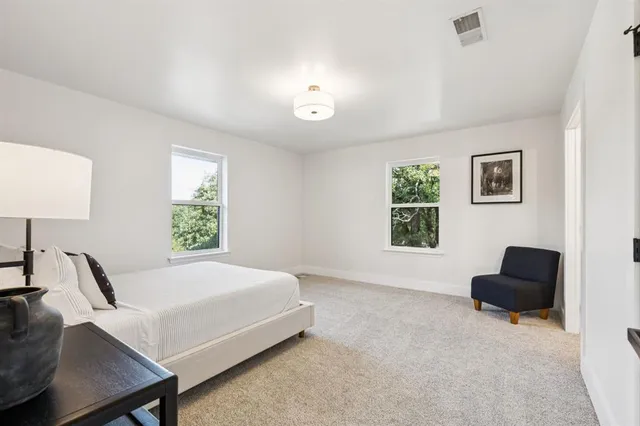 a bedroom with a bed and a couch