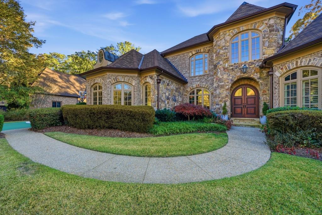 841 Camden Park Court Atlanta, GA 30342 - Photo 102 of 120 a front view of a house with garden