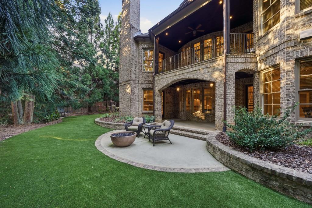 841 Camden Park Court Atlanta, GA 30342 - Photo 105 of 120 a view of a patio with table and chairs and potted plants with large tree