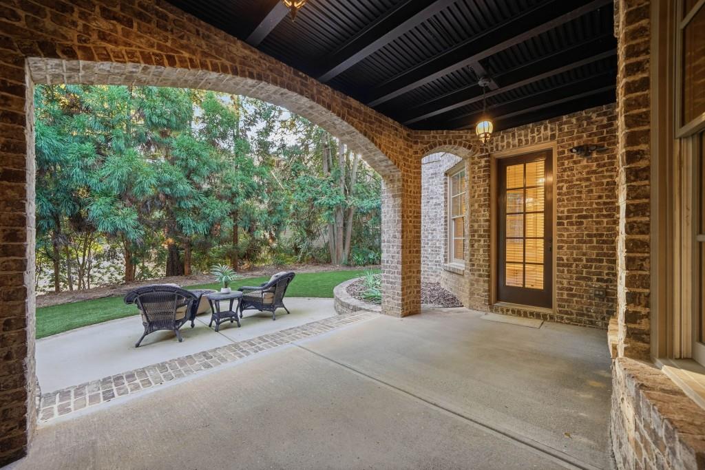841 Camden Park Court Atlanta, GA 30342 - Photo 115 of 120 a view of a patio with table and chairs next to a yard
