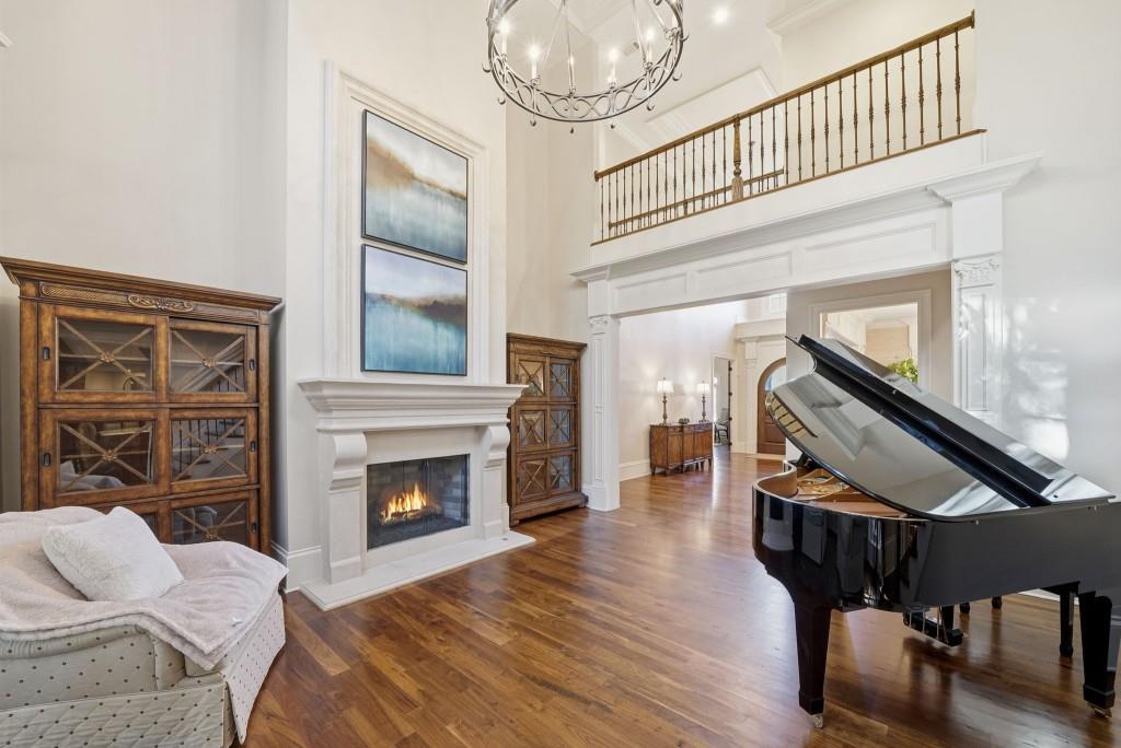 841 Camden Park Court Atlanta, GA 30342 - Photo 35 of 120 a living room with furniture a fireplace and a floor to ceiling window