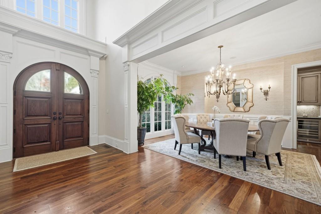 841 Camden Park Court Atlanta, GA 30342 - Photo 40 of 120 a dining room with furniture a chandelier and wooden floor