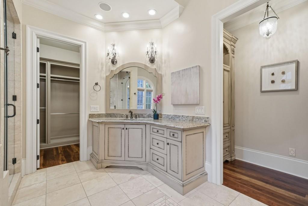841 Camden Park Court Atlanta, GA 30342 - Photo 59 of 120 a bathroom with a granite countertop sink a mirror and a shower