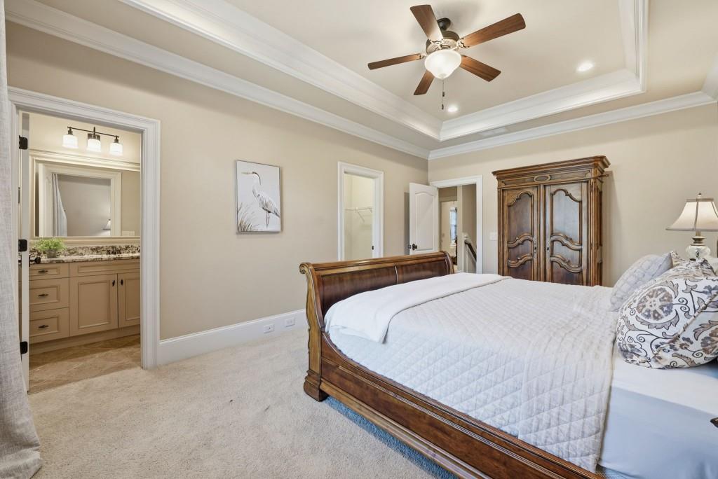 841 Camden Park Court Atlanta, GA 30342 - Photo 66 of 120 a bedroom with a bed and a chandelier