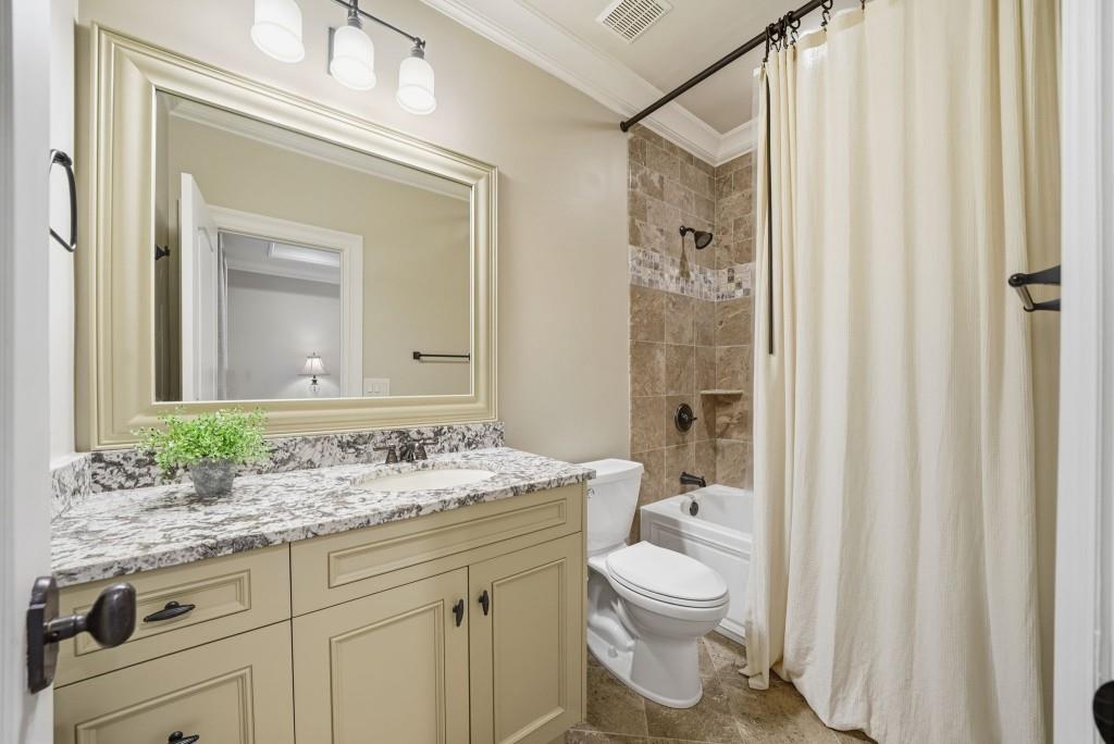 841 Camden Park Court Atlanta, GA 30342 - Photo 67 of 120 a bathroom with a granite countertop sink toilet a mirror and shower