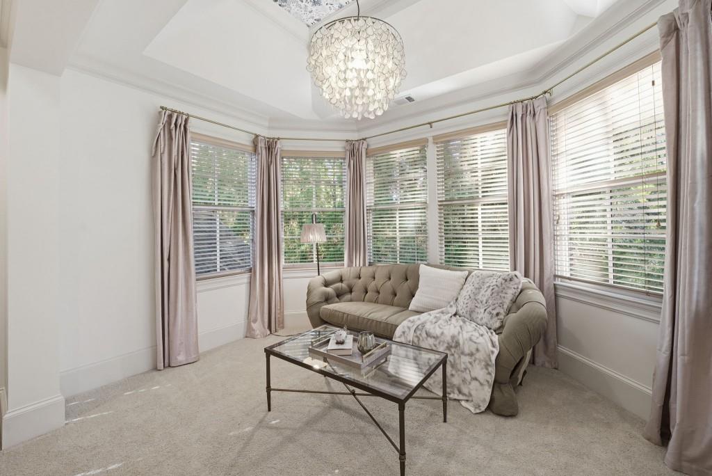 841 Camden Park Court Atlanta, GA 30342 - Photo 69 of 120 a living room with furniture and a chandelier