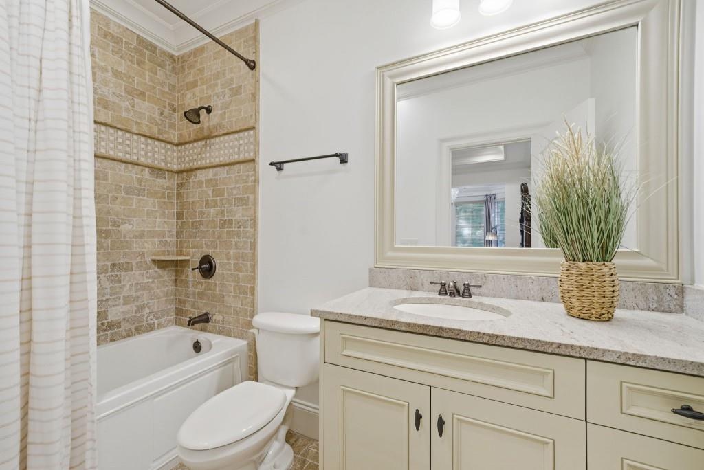 841 Camden Park Court Atlanta, GA 30342 - Photo 71 of 120 a bathroom with a granite countertop sink a mirror a bathtub and shower