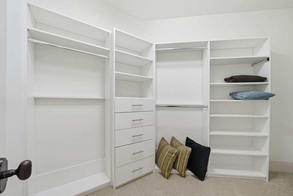 841 Camden Park Court Atlanta, GA 30342 - Photo 72 of 120 a view of walk in closet with empty racks