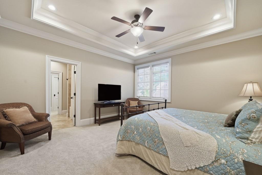 841 Camden Park Court Atlanta, GA 30342 - Photo 73 of 120 a bedroom with a bed a couch and a flat screen tv