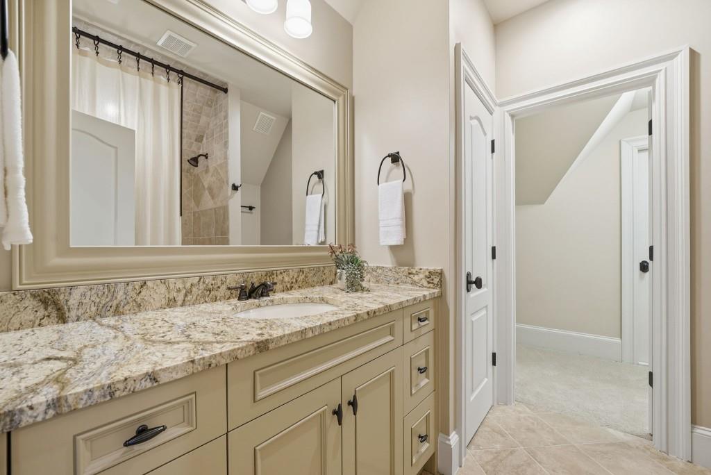 841 Camden Park Court Atlanta, GA 30342 - Photo 75 of 120 a bathroom with a granite countertop sink and a mirror