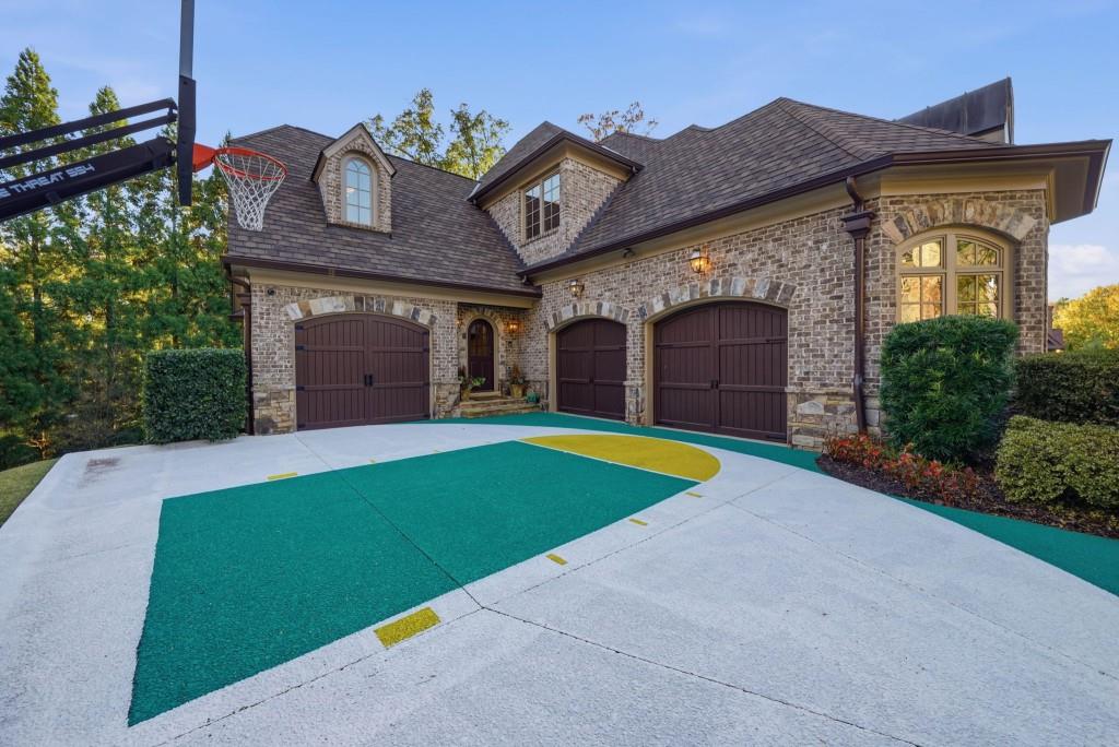 841 Camden Park Court Atlanta, GA 30342 - Photo 100 of 120 a front view of a house with a yard and garage