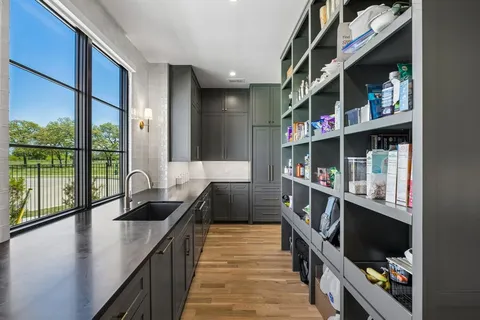 a kitchen with stainless steel appliances a sink and a wooden floors